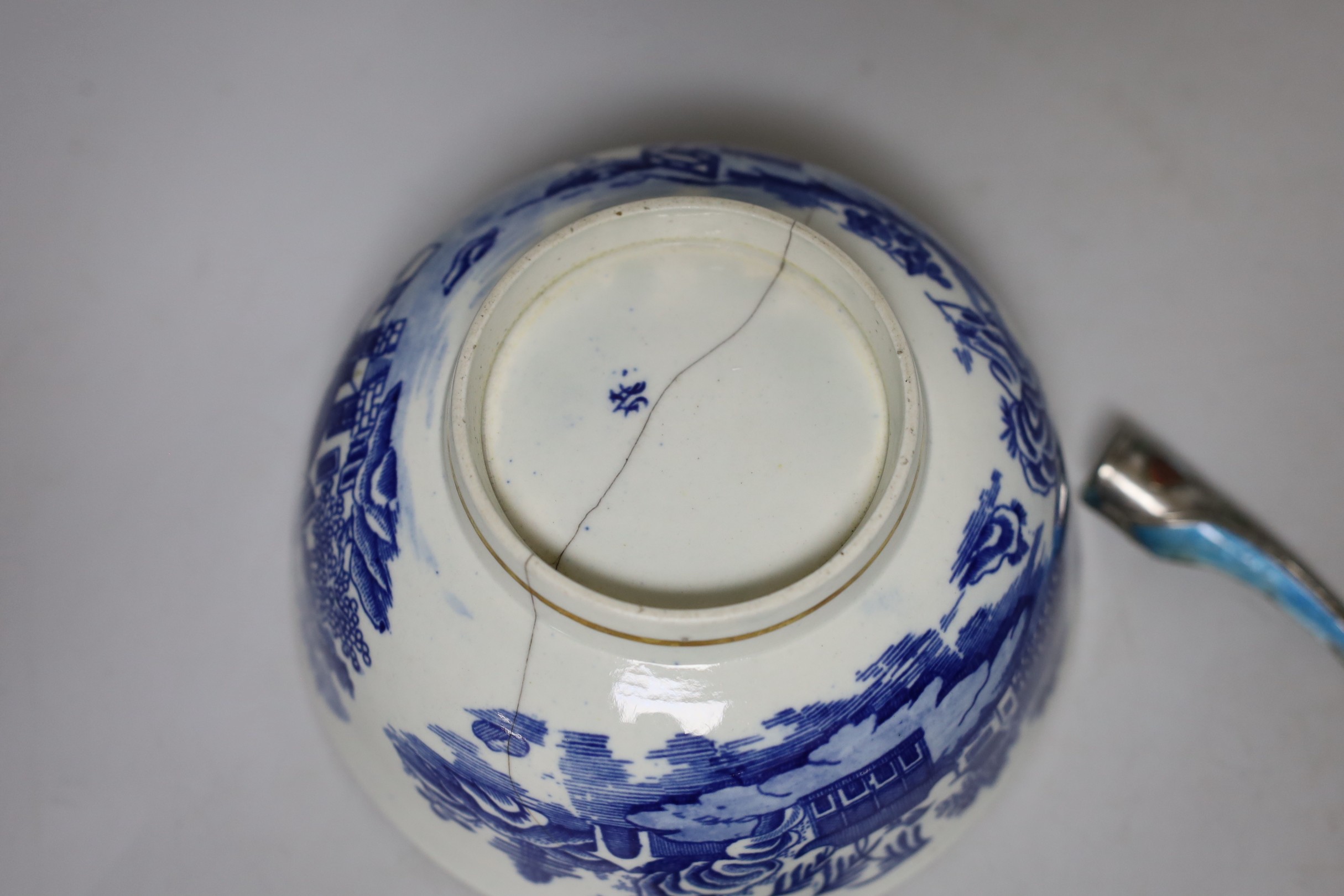 An English porcelain blue and white slop bowl, 15cm diameter, together with three miniature Chinese tea bowls and one nail guard
